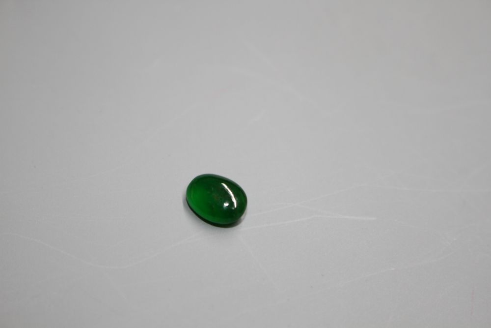 An unmounted cabochon cut jadeite stone, with GCS certificate dated 25/02/20